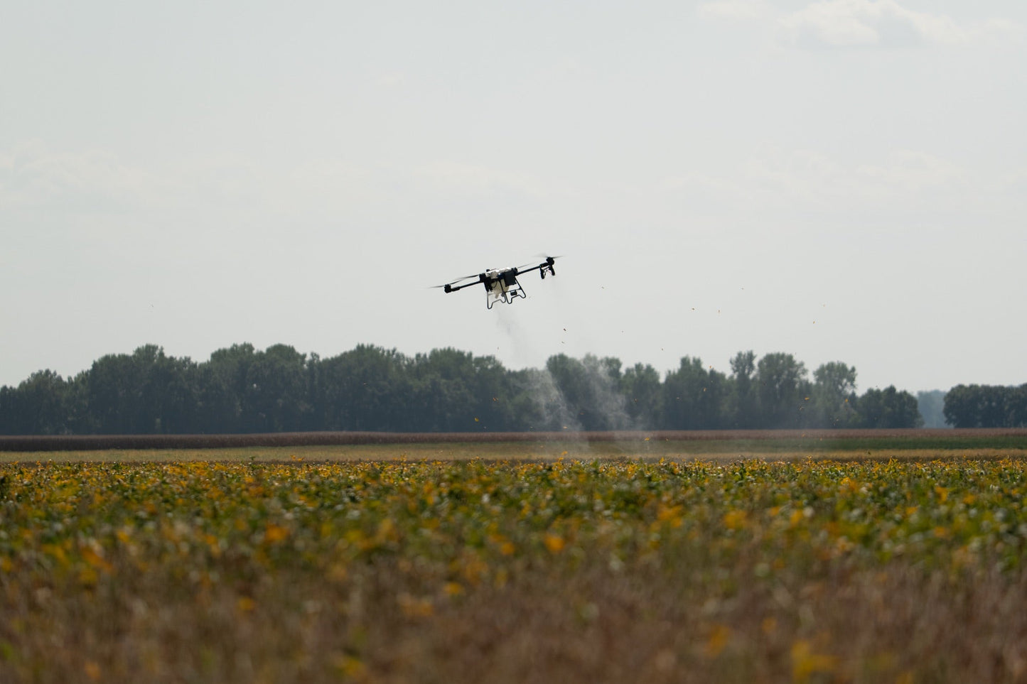 EAVision J150 spray drone applying fungicide across a large northern Illinois field