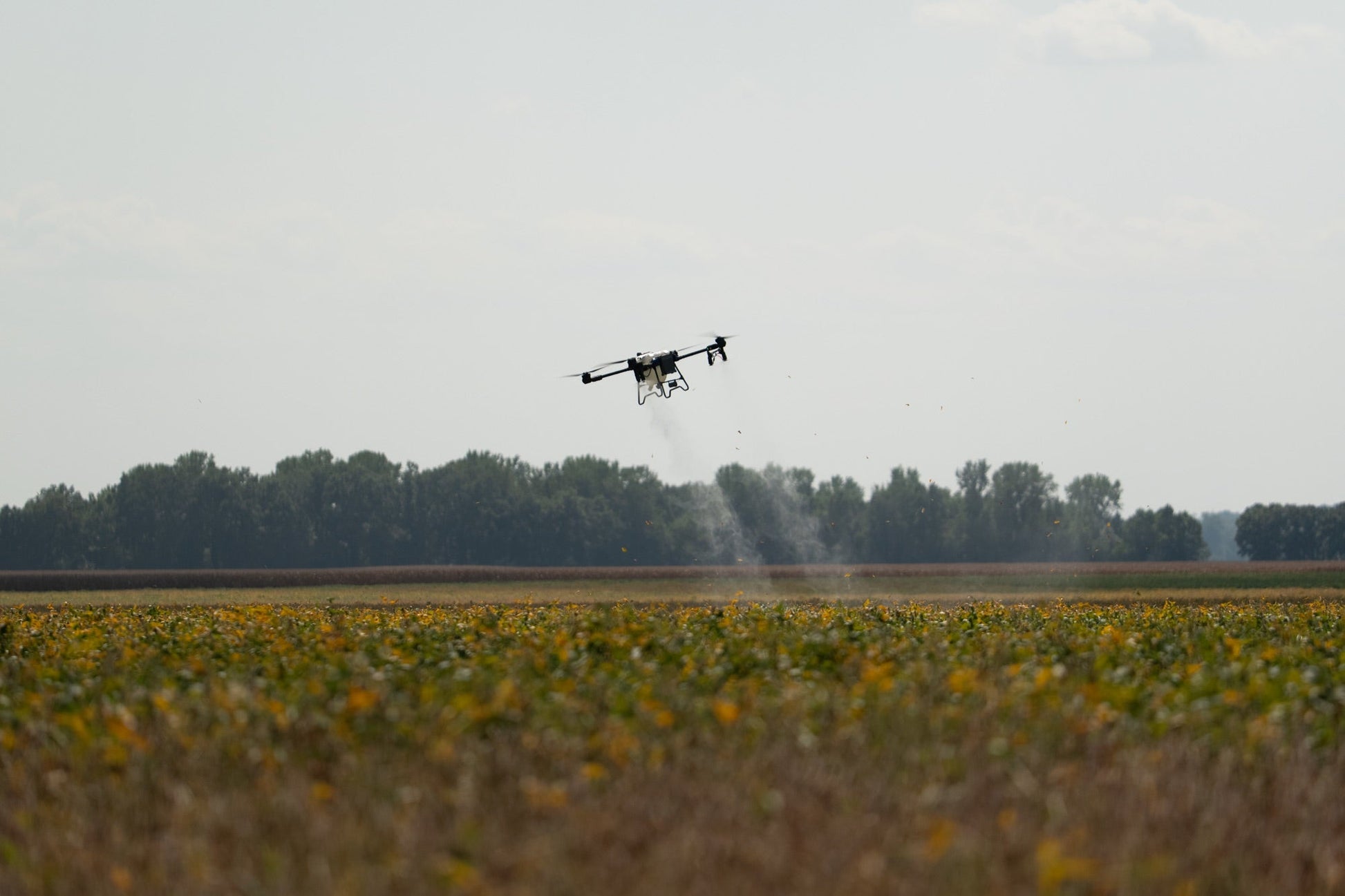 EAVision J150 spray drone applying fungicide across a large northern Illinois field